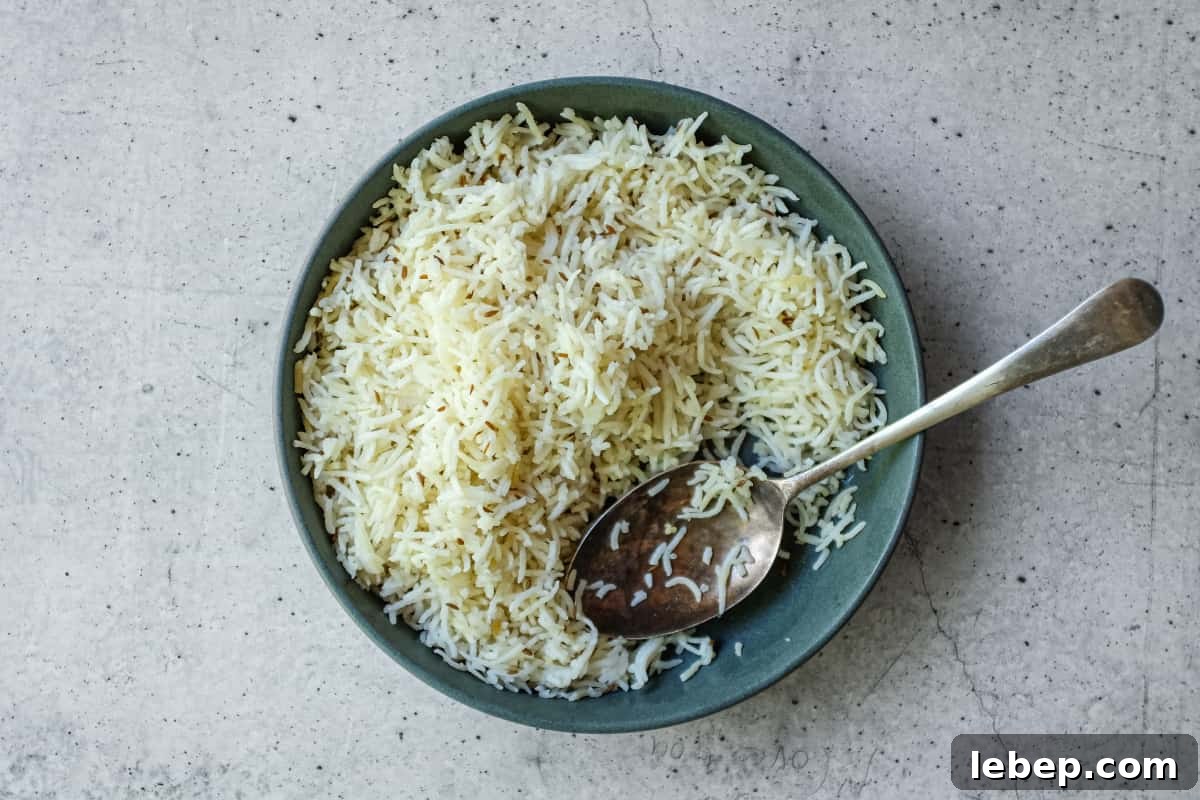 Homemade jeera rice with ghee and toasted cumin seeds in a serving bowl