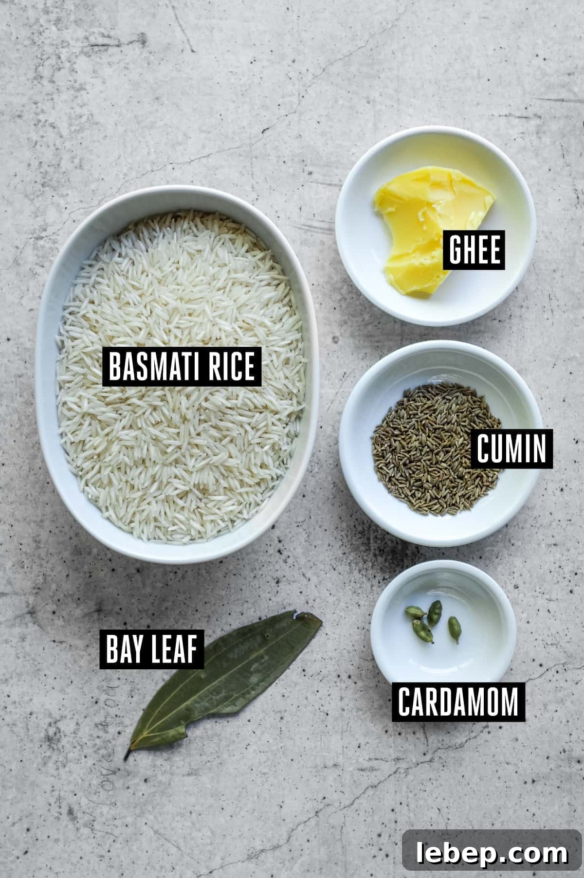 The ingredients for Indian Jeera Rice: Basmati Rice, Ghee, Cumin Seeds, Cardamom Seeds, Bay Leaf.
