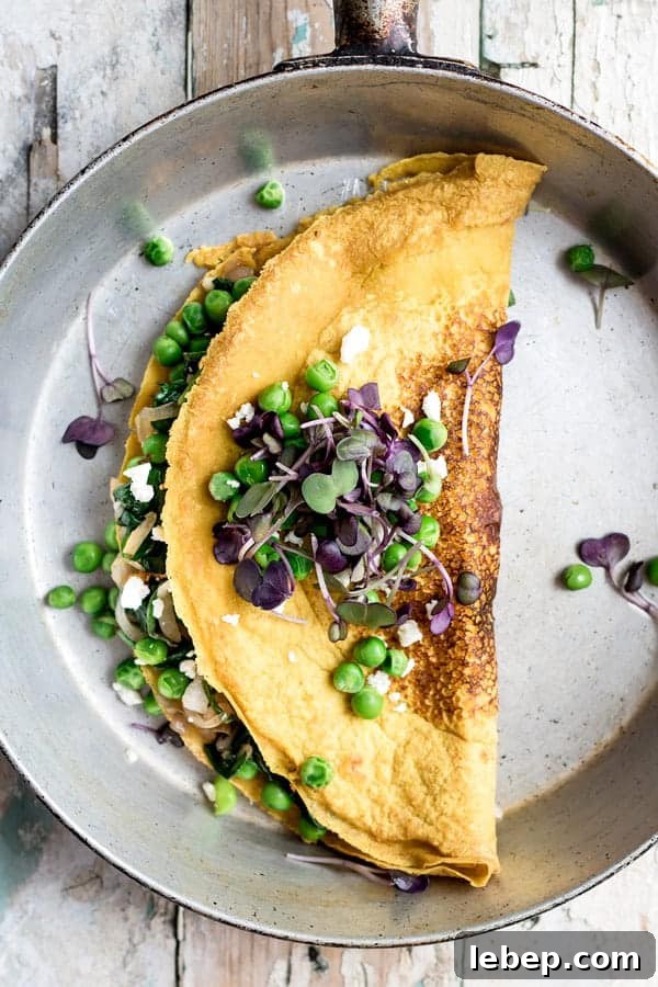 Chickpea omelette with spinach and spring peas