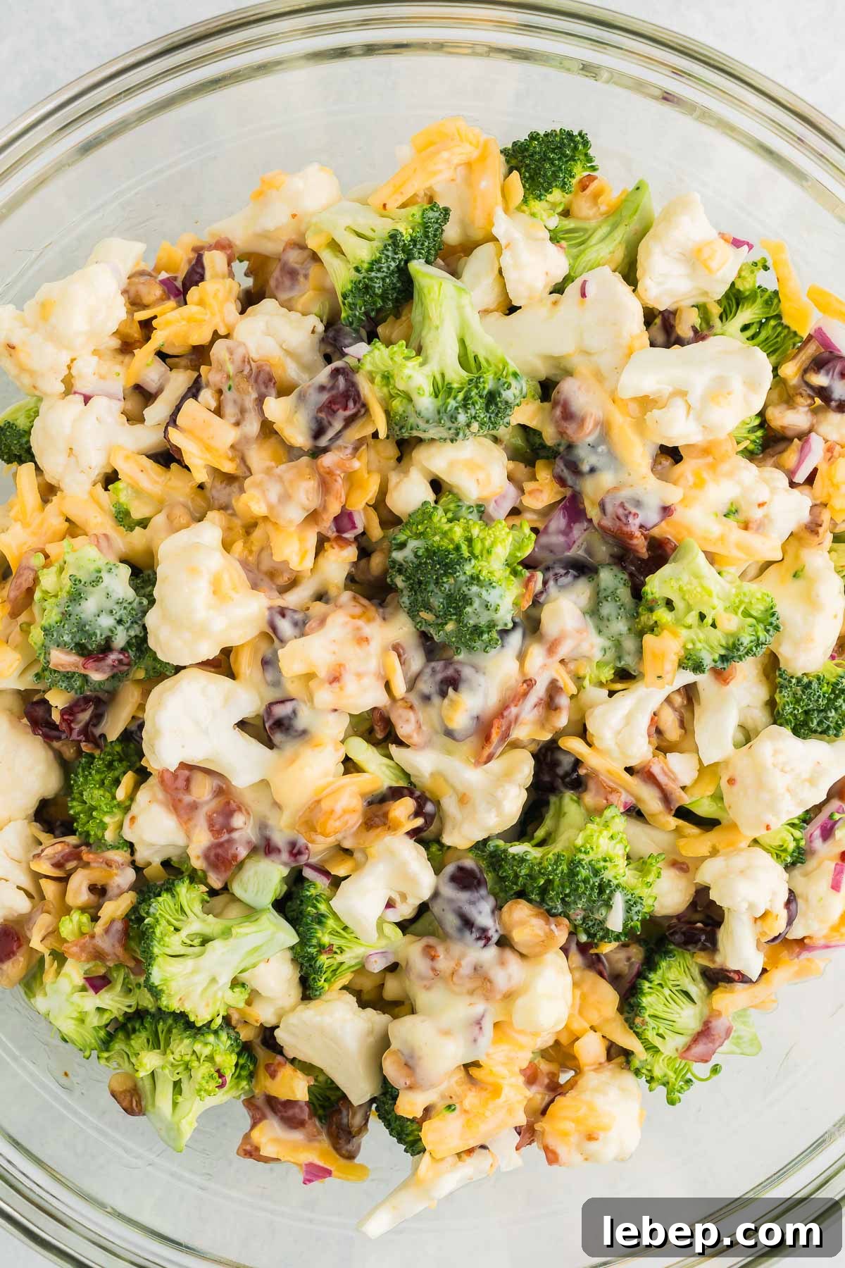 salad with broccoli and cauliflower in a bowl with cheese and bacon