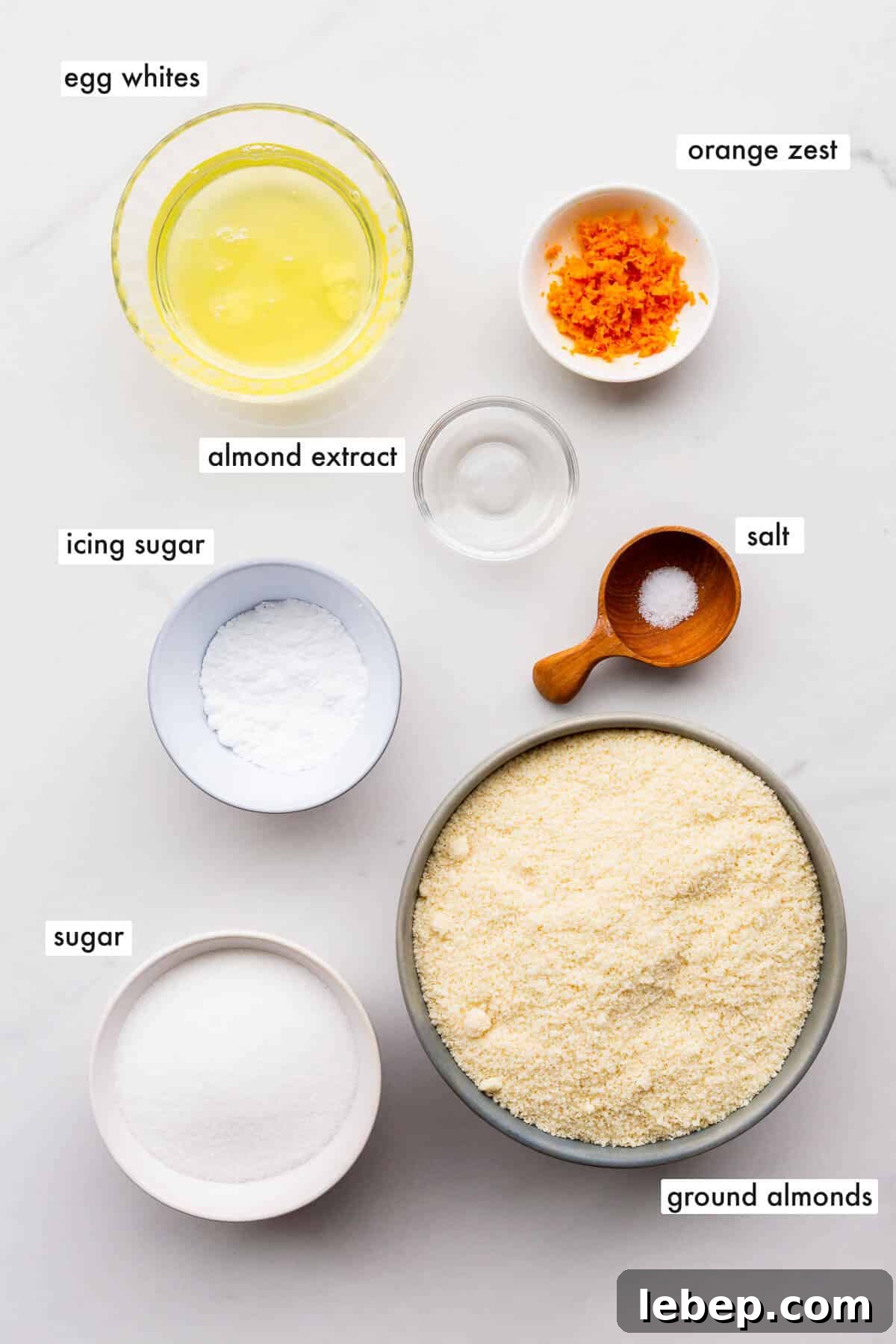 Orange Almond Amaretti Cookies Recipe — Zesty, Chewy Biscotti-Style Treats 3 Ingredients to make amaretti cookies measured out into small bowls.