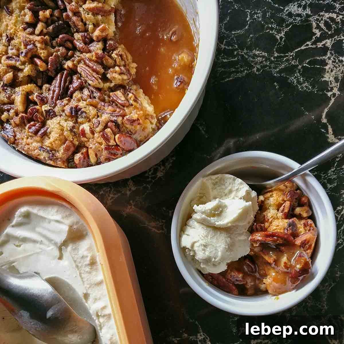 Pecan Pie Cobbler Recipe: Southern-Styled Gooey Pecan Dessert 14 A dish of pecan pie cobbler with a scoop of ice cream on top.