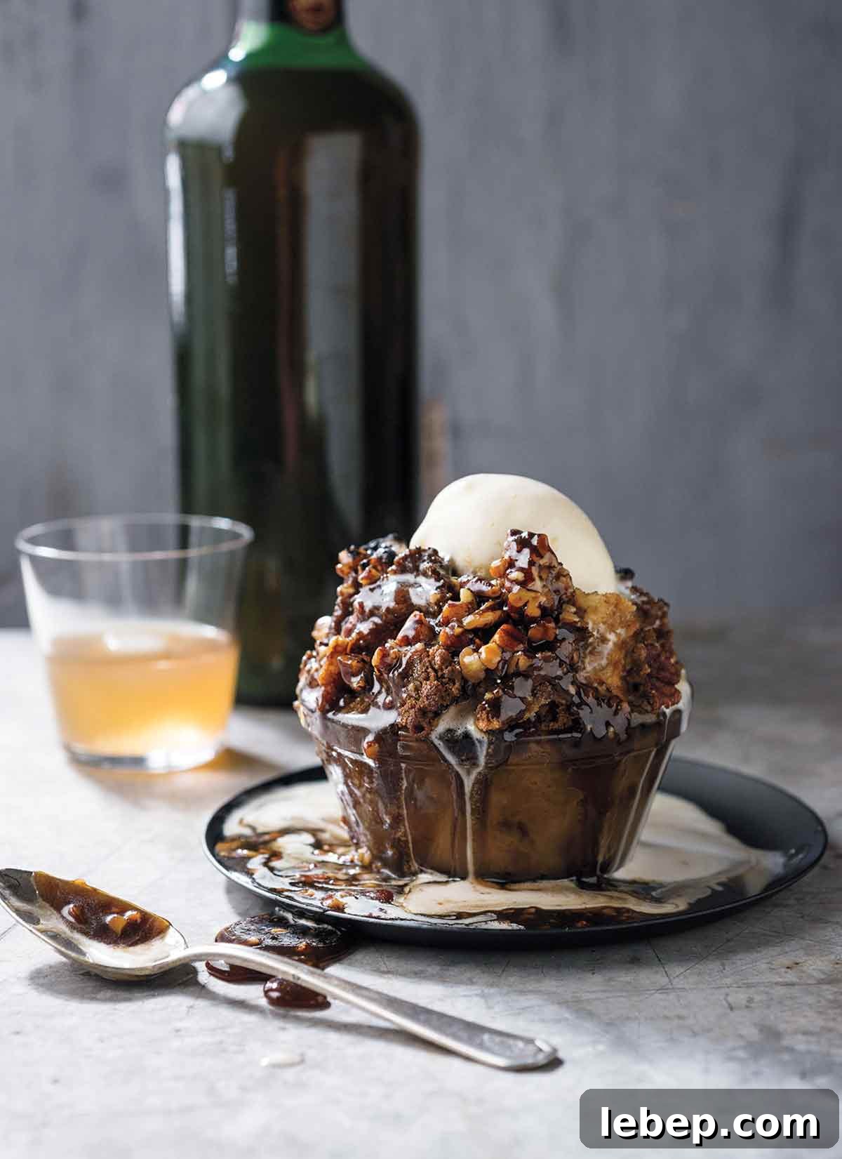 Pecan Pie Cobbler Recipe: Southern-Styled Gooey Pecan Dessert 10 Glass bowl filled with pecan pie bread pudding, caramel sauce, bourbon-vanilla ice cream on a marble table