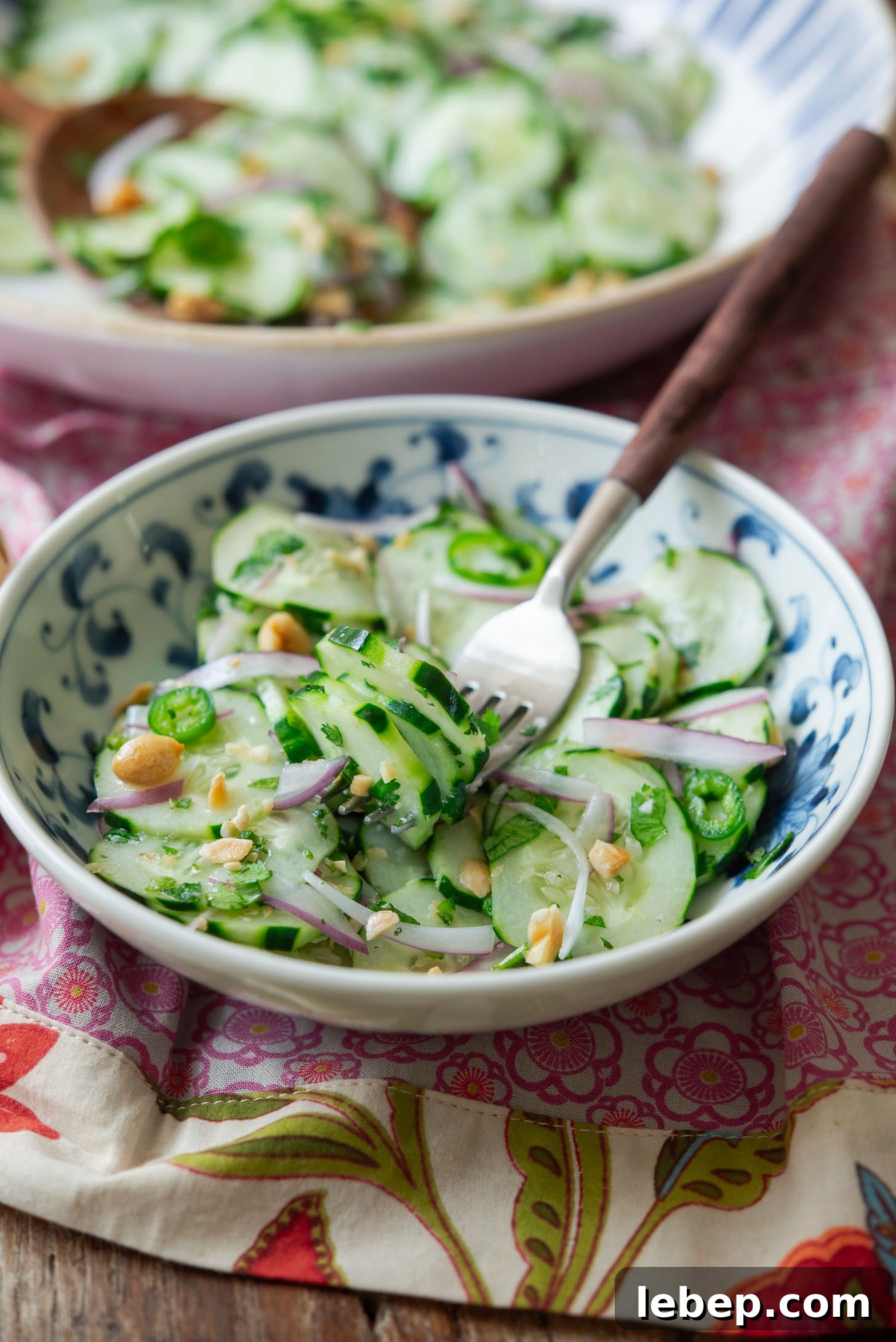 A bowl of Vietnamese cucumber salad with a fork.