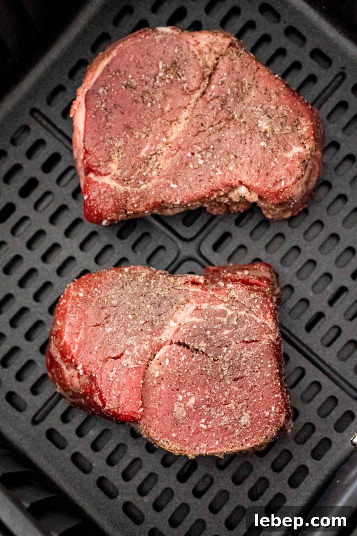 Perfect Air Fryer Filet Mignon Recipe for Tender Steak 5 Steaks in air fryer ready to be cooked.