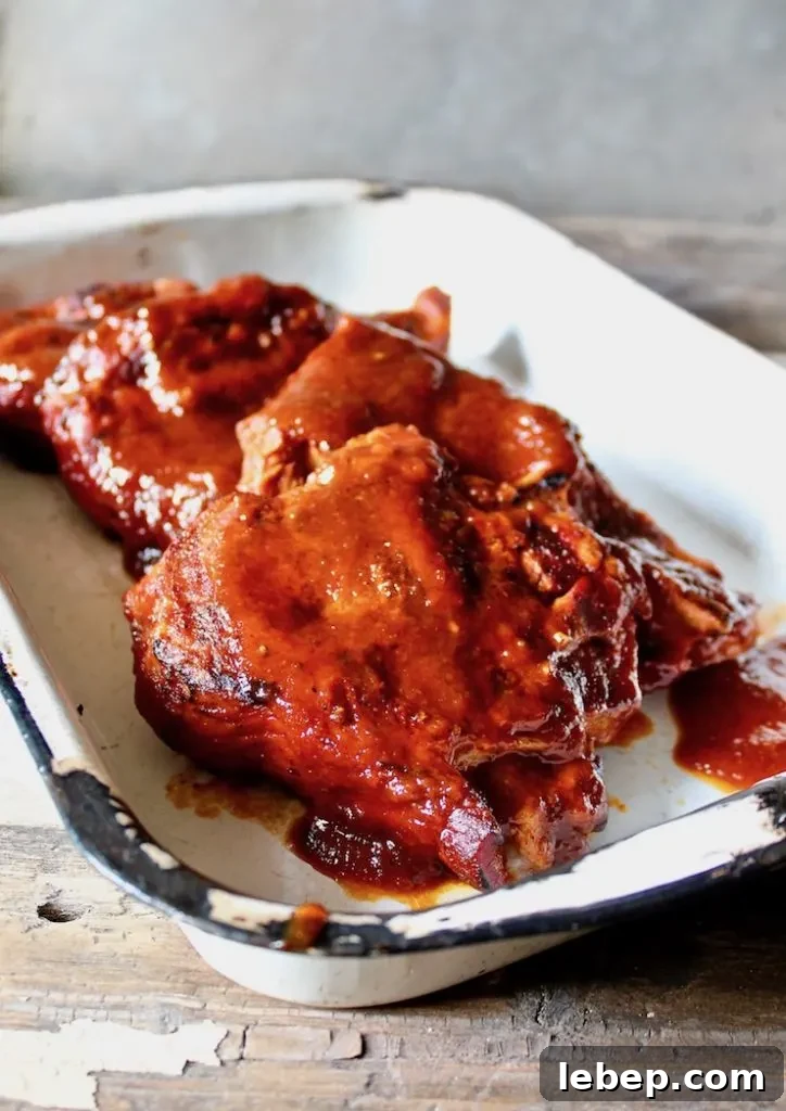 St. Louis Style BBQ Pork Steaks — Juicy Grilled Recipe 7 St. Louis BBQ Pork Steaks close up shot in serving pan.