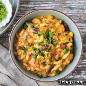 Bowl of vegan chili mac with kidney beans topped with chopped fresh cilantro.