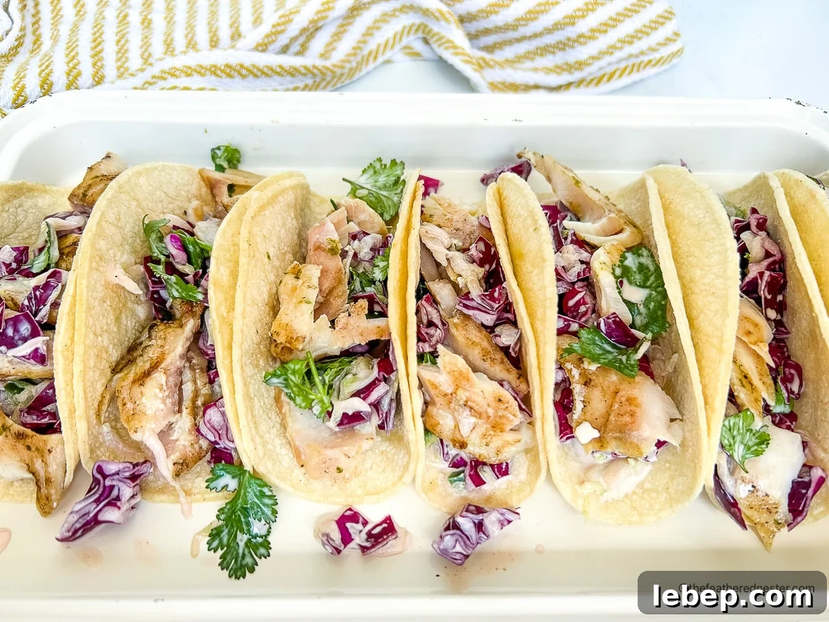Hawaiian rock cod and cucumber slaw inside of soft corn tortillas.