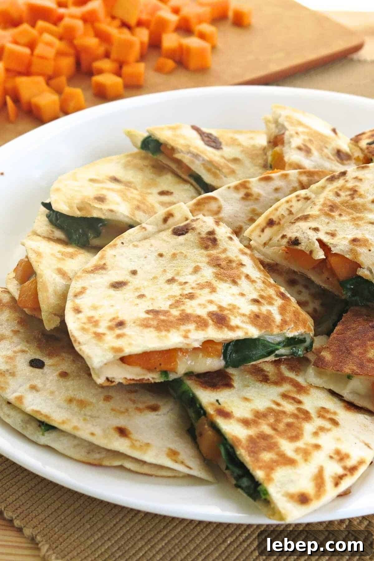 A plate of quesadillas made with butternut squash, spinach, and cheese.