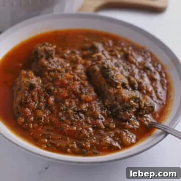 A large bowl of spinach beef stew.