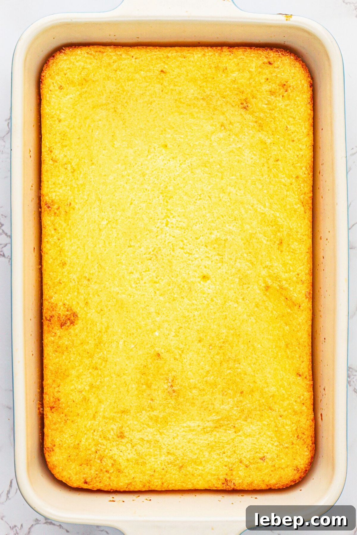 Lemon cake mix and pie filling in pie dish after they have been mixed and baked in a 9x13 baking dish.