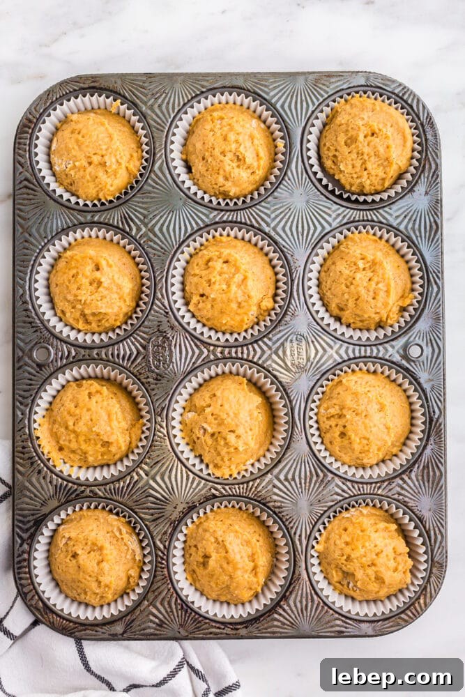 Fluffy Pumpkin Muffins with Cream Cheese Swirl 11 picture of pumpkin batter in a muffin tin