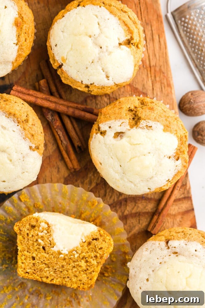 Fluffy Pumpkin Muffins with Cream Cheese Swirl 17 picture of muffin in muffin wrapper cut in half