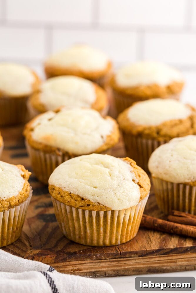 Fluffy Pumpkin Muffins with Cream Cheese Swirl 18 picture of pumpkin cream cheese muffins on a wood tray