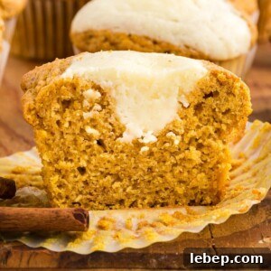 Fluffy Pumpkin Muffins with Cream Cheese Swirl 24 picture of muffin with cream cheese cut in half