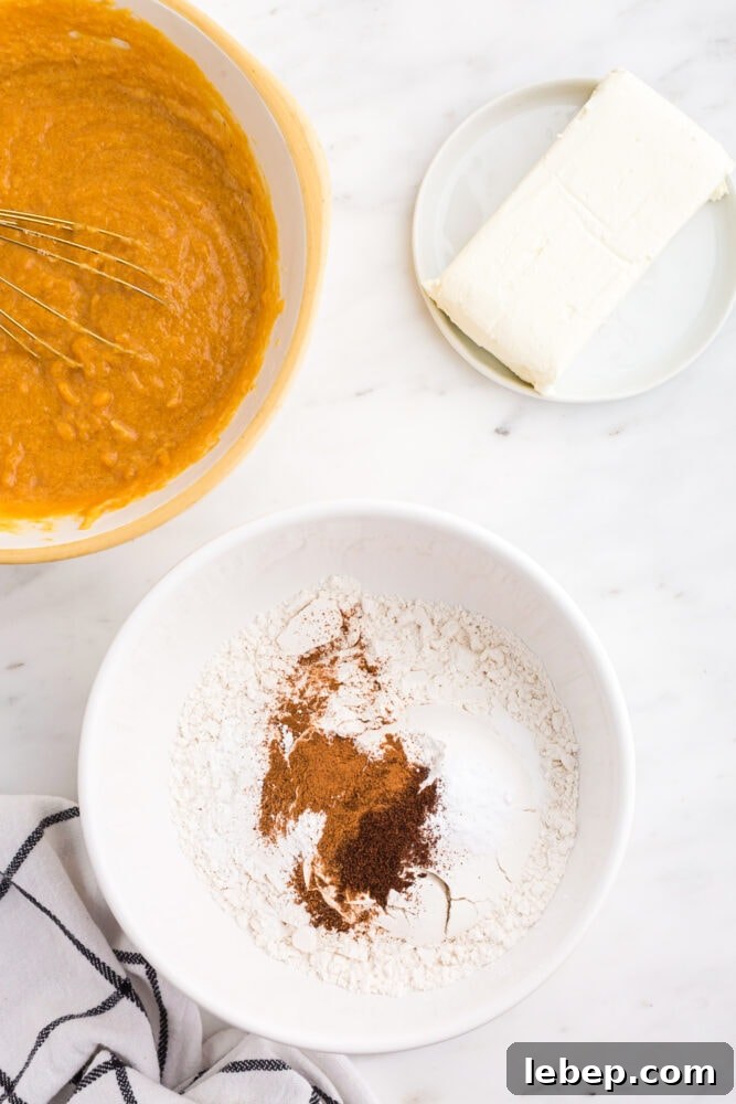 Fluffy Pumpkin Muffins with Cream Cheese Swirl 8 picture of cinnamon and flour being mixed in a bowl