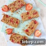 A delicious soft oat bar recipe packed full with sweet strawberries. A tasty and healthy snack for toddlers and older kids!