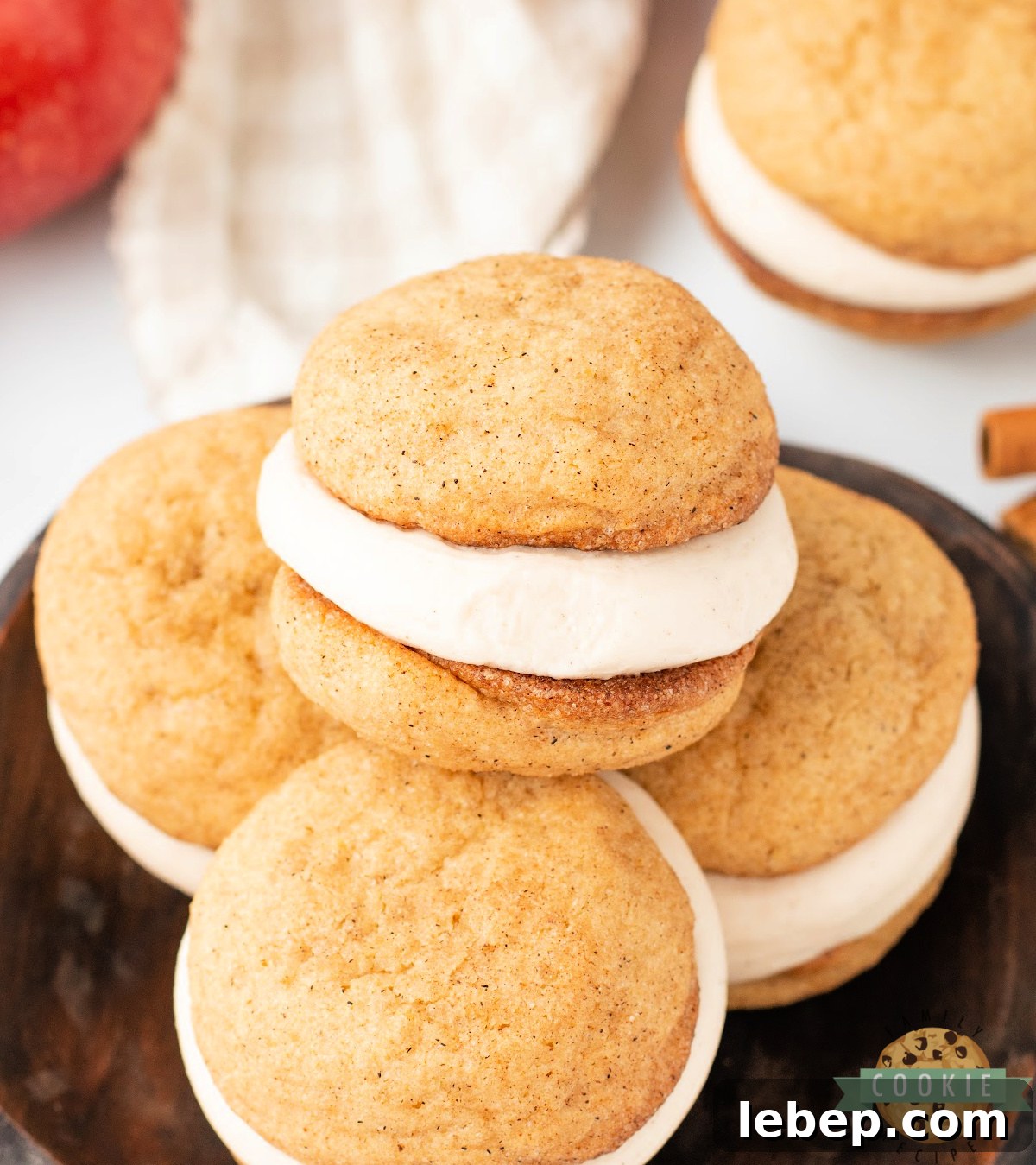 Close-up of Apple Cider Snickerdoodle Cream Pies with spiced cookies and creamy apple cider frosting filling.