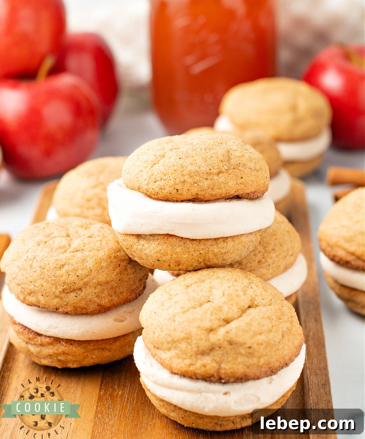 Stack of soft and chewy apple cider snickerdoodle cream pies showing the frosting layer inside.