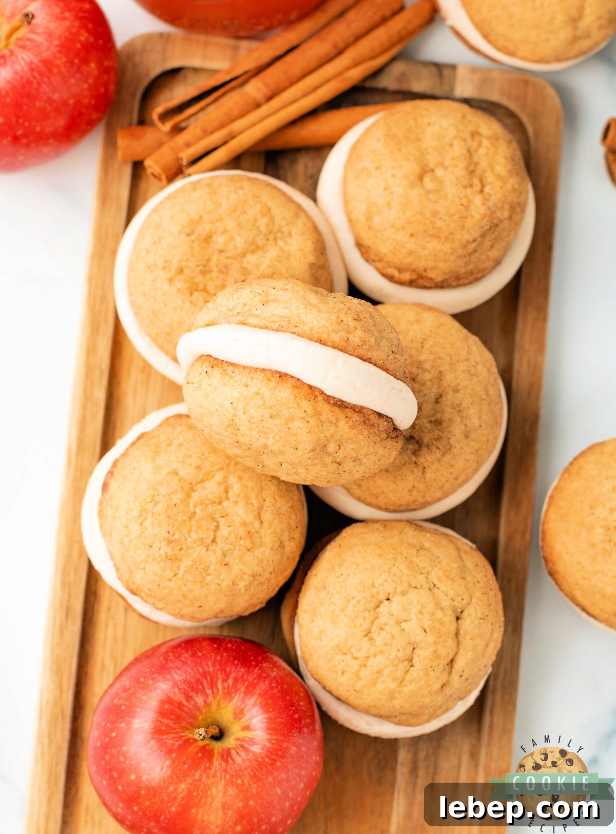 Plate of homemade snickerdoodle cream pies dusted with cinnamon sugar, perfect fall dessert.