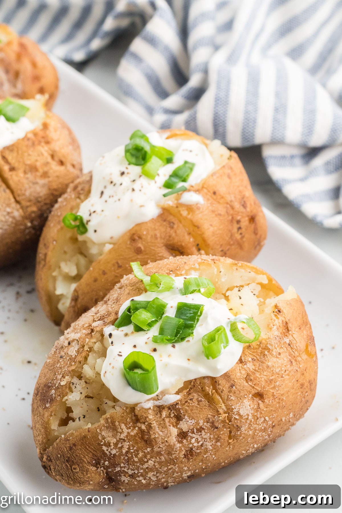 Smoked Baked Potatoes Recipe: Crispy Skin, Smoky Flavor 8 Smoked baked potatoes topped with sour cream and chives