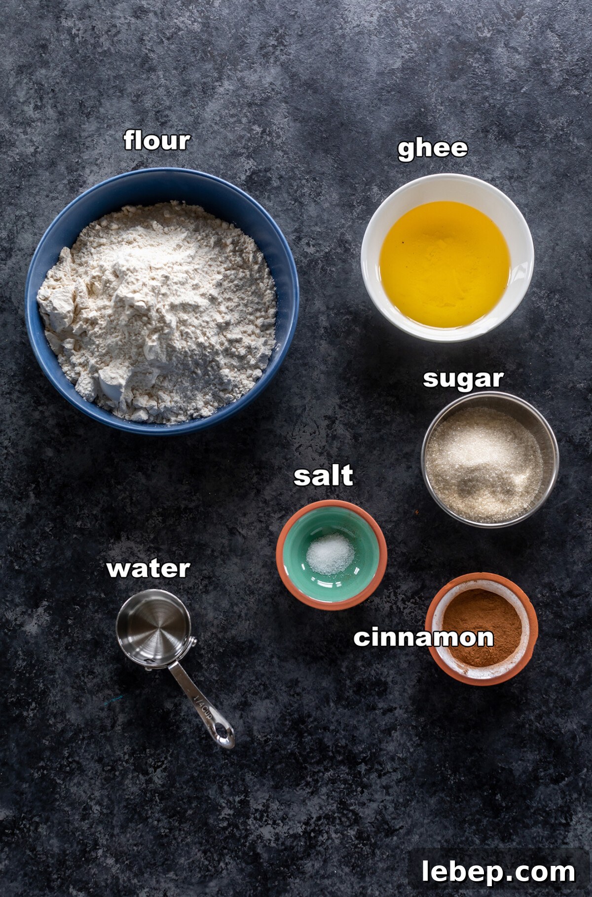 ingredients for cinnamon sugar shakarpara arranged on a board