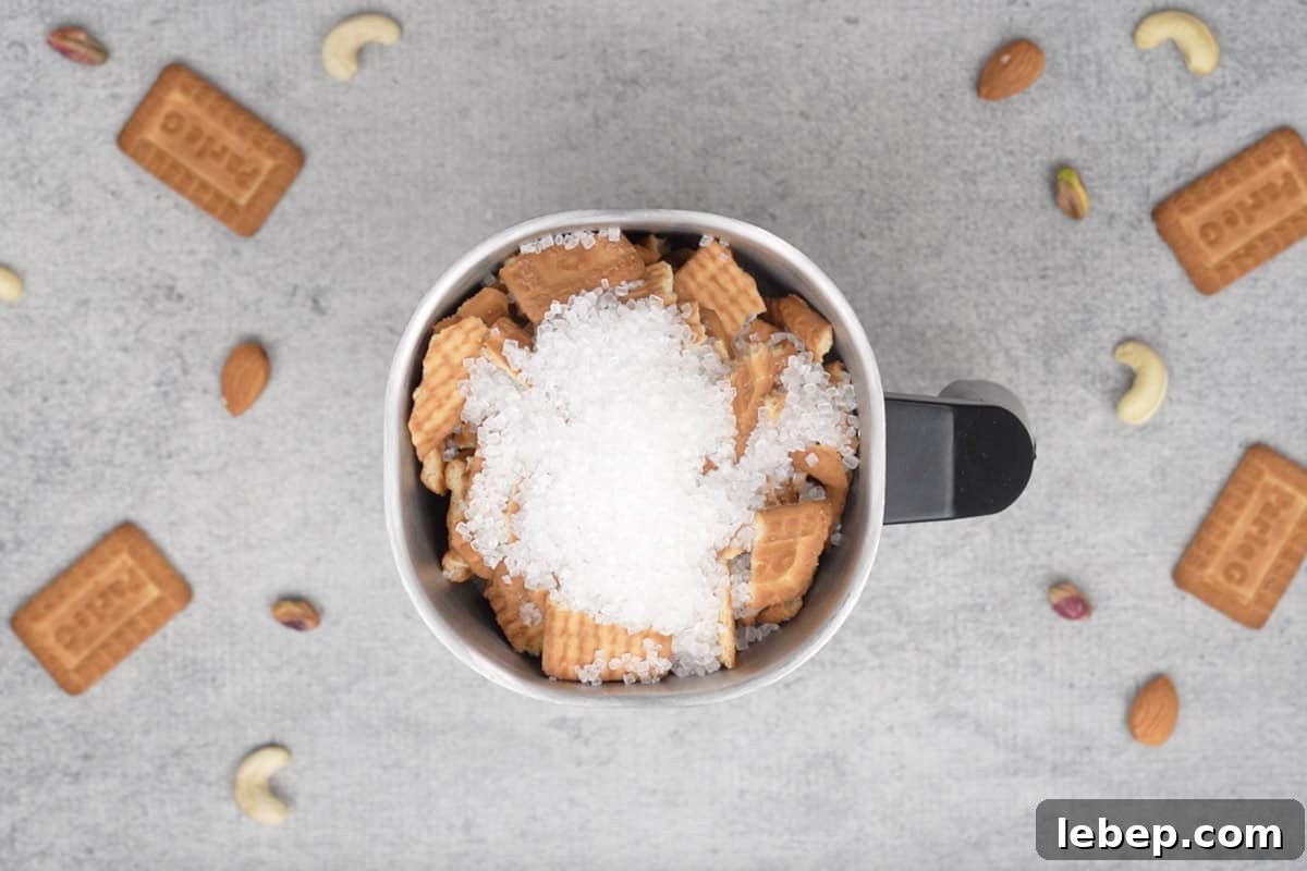 Broken biscuits and sugar added to a blender.