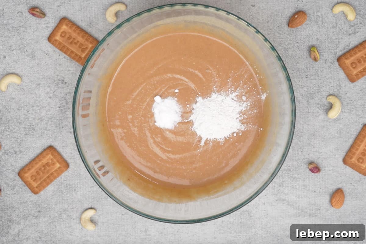 Baking powder and baking soda added to the bowl.