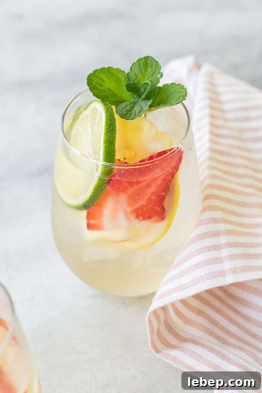 Top Brunch Cocktails to Impress Your Guests 11 A glass of white wine sangria with strawberries, limes, lemons, apple vodka and pear liqueur.