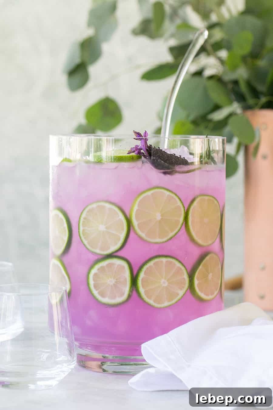 Top Brunch Cocktails to Impress Your Guests 15 Lavender gin and tonic in large pitcher with lime slices