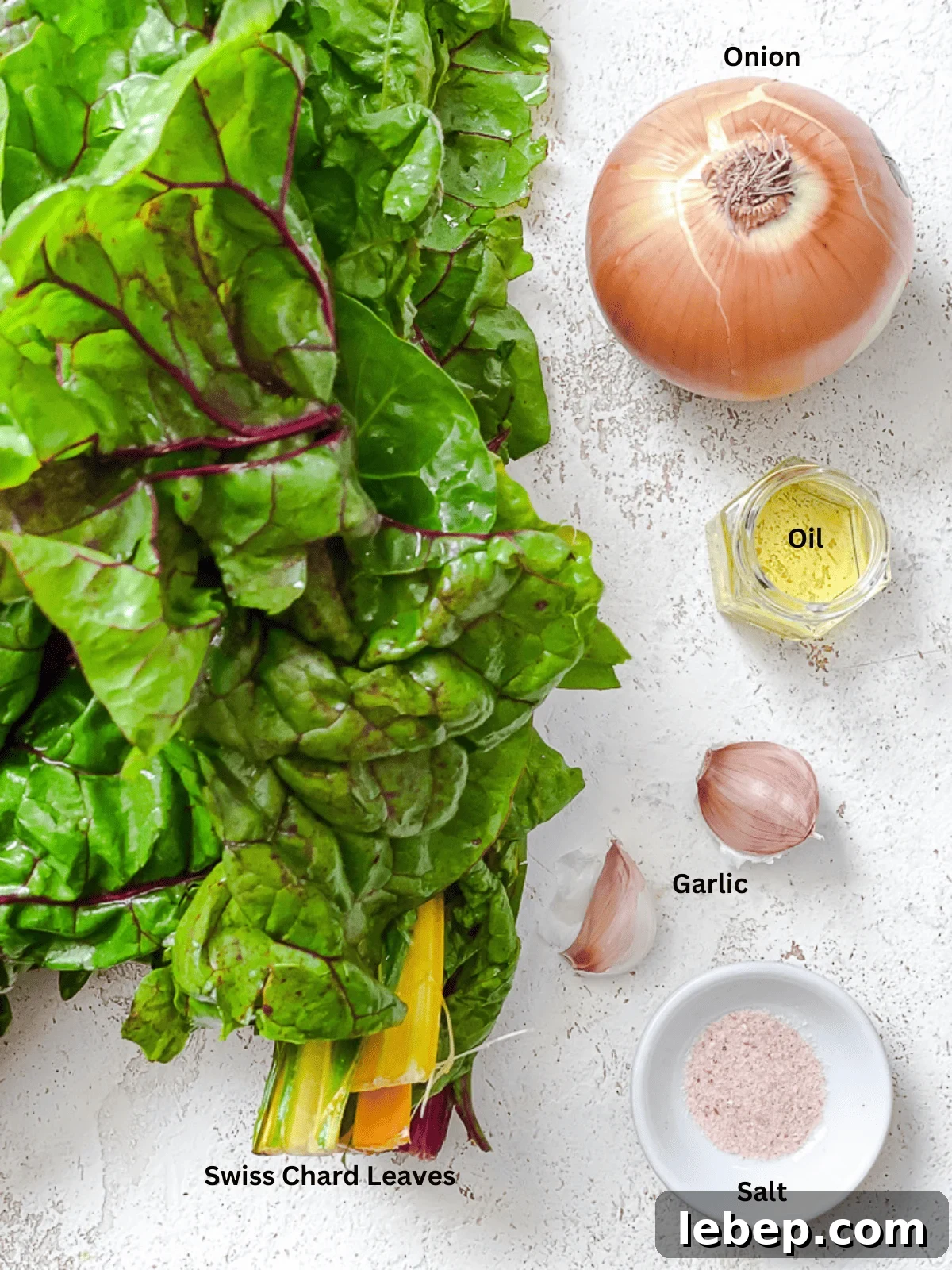 ingredients for Sautéed Swiss Chard [with Garlic] on a white surface