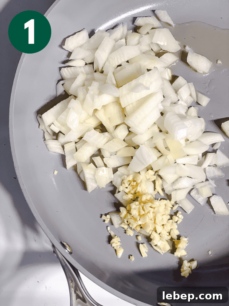 process shot of garlic and onion cooking in pan