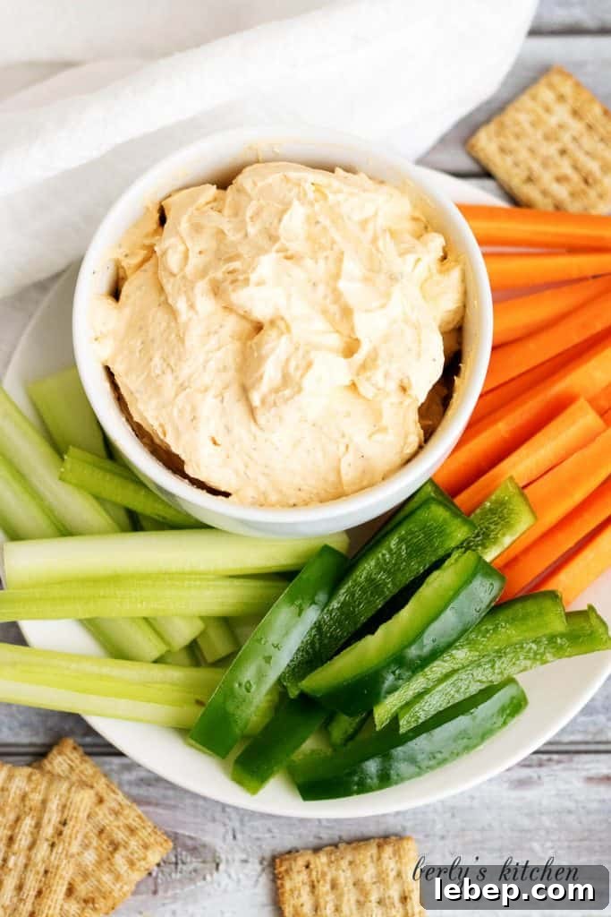 Creamy Buffalo Chicken Dip Recipe for Parties and Game Day 3 Top down view of dip in bowl with celery, peppers, and carrot sticks.