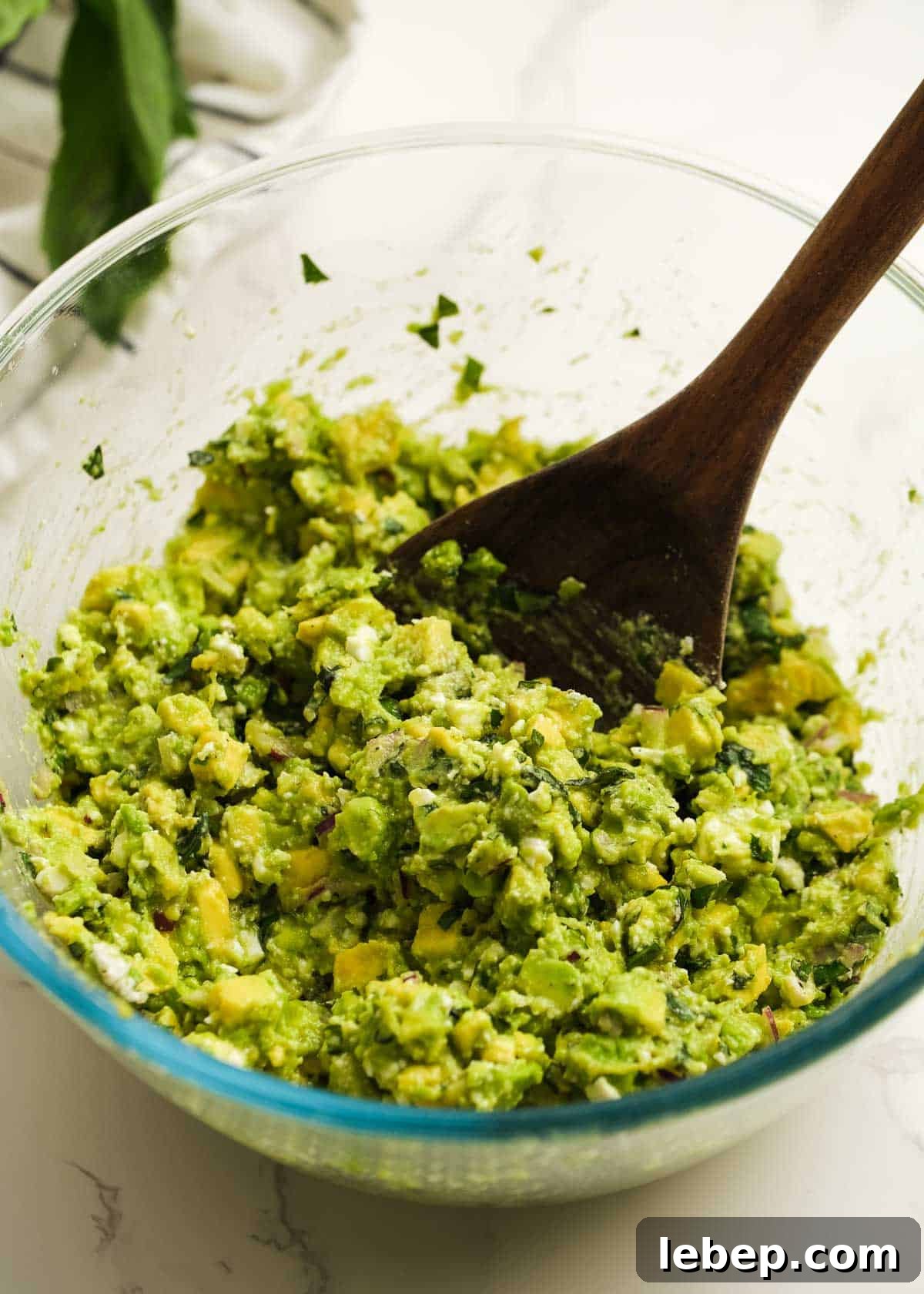 Creamy Avocado and Feta Dip Recipe for Parties and Snacks 5 avocado dip in a bowl with a spoon