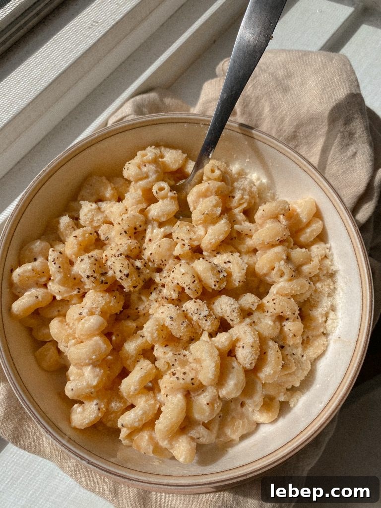 Creamy Cavatappi Pasta with Gluten-Free and Dairy-Free Options 3 creamy cavatappi pasta in a white bowl with a dish towel
