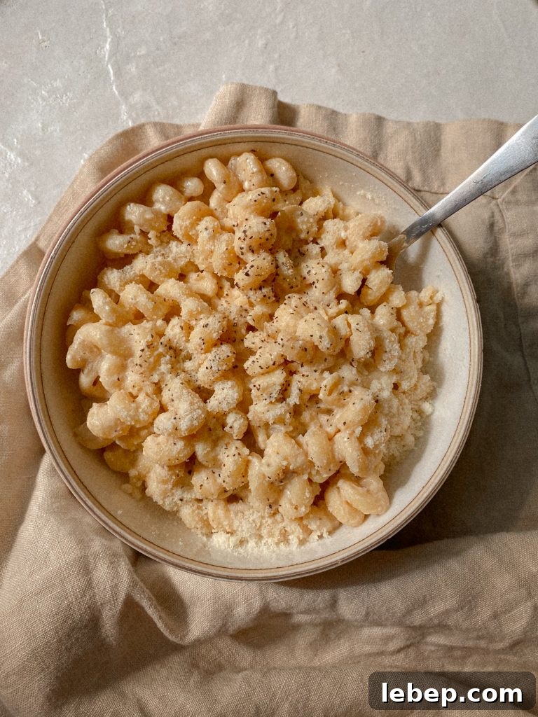 Creamy Cavatappi Pasta with Gluten-Free and Dairy-Free Options 4 creamy cavatappi pasta in a white bowl with a dish towel