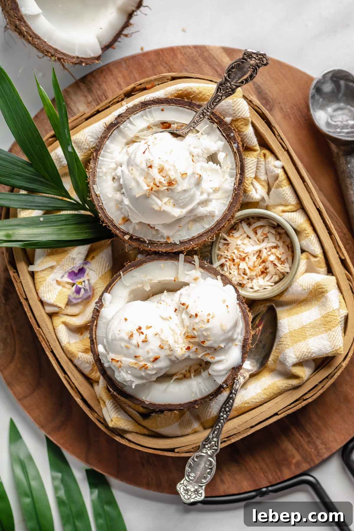 Creamy Coconut Sorbet Recipe: Refreshing Tropical Dessert 3 Two coconut shells in a basket filled with coconut sorbet.