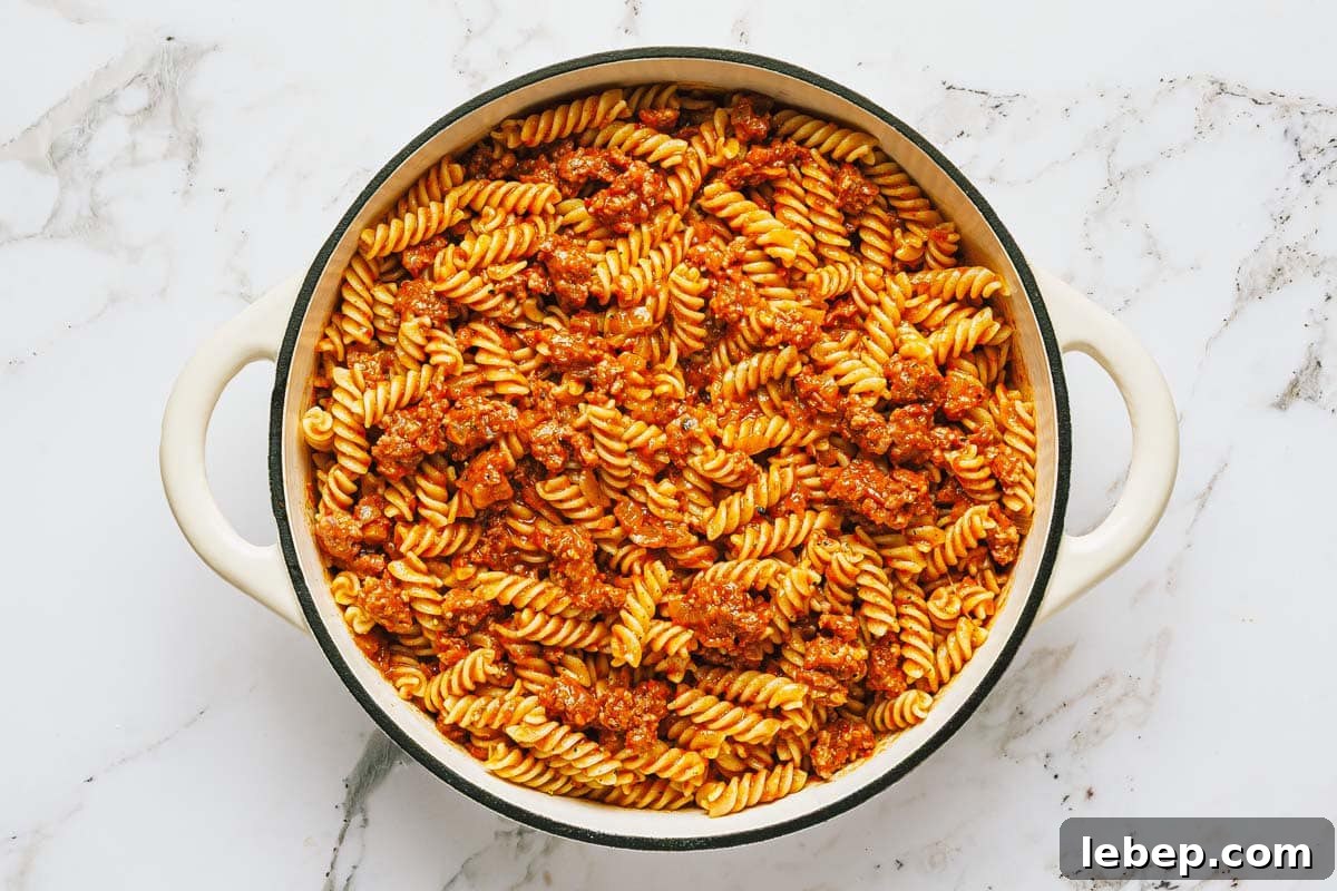 Pepperoni & Sausage Pizza Pasta Bake Recipe 6 Large pan filled with spaghetti sauce and pasta.