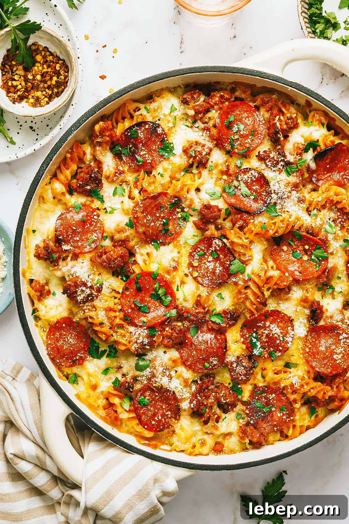 Pepperoni & Sausage Pizza Pasta Bake Recipe 8 Large pan filled with easy pepperoni pizza pasta garnished with parsley.