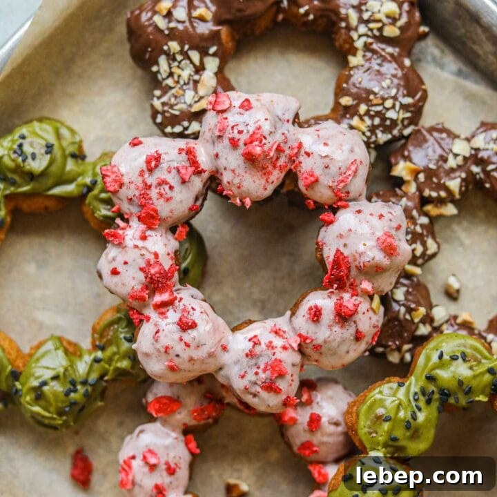 Closeup of donuts with strawberry, Nutella chocolate, and matcha glaze.
