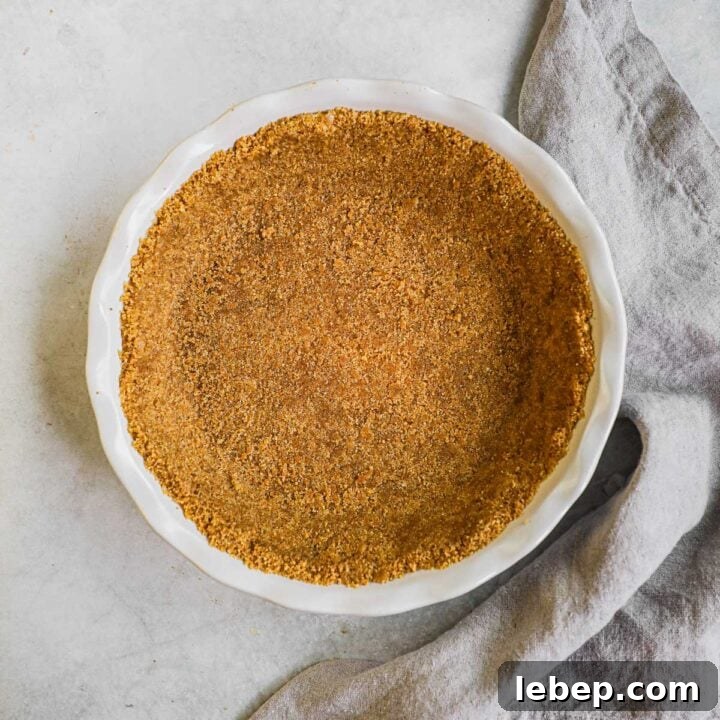 Homemade graham cracker crust in an Emile Henry pie dish for pies, cheesecakes, and more.