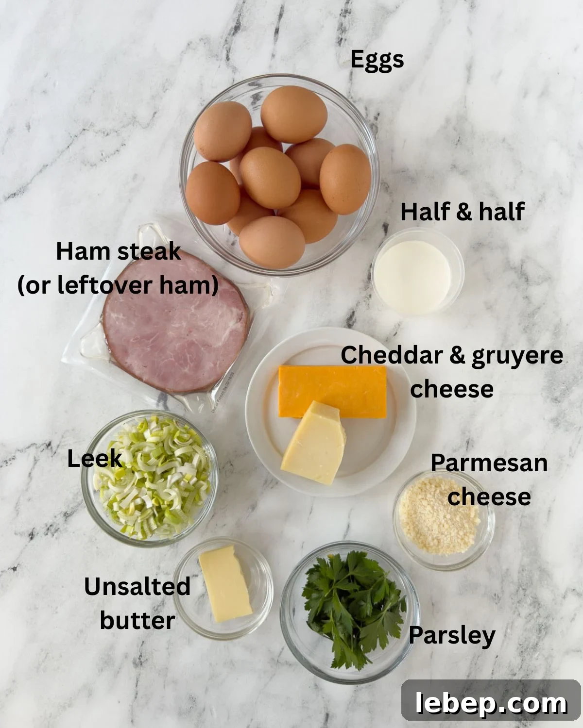 Ham and cheese frittata ingredients in prep bowls on a counter.