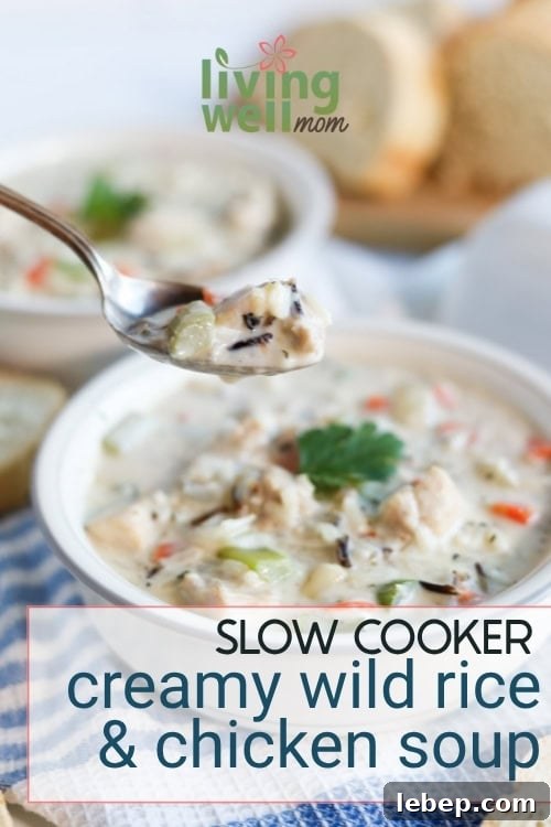 Creamy Slow Cooker Wild Rice and Chicken Soup Recipe 2 A hearty spoonful of slow cooker creamy chicken and wild rice soup with bread in background