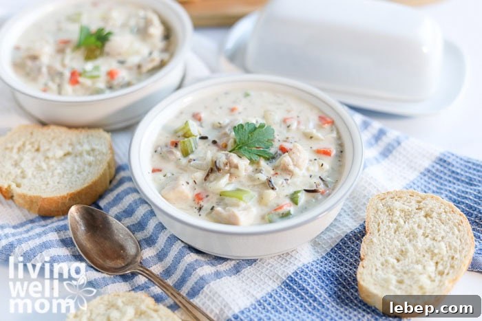 Creamy Slow Cooker Wild Rice and Chicken Soup Recipe 10 Slow cooker creamy wild rice soup in 2 bowls alongside crusty french bread