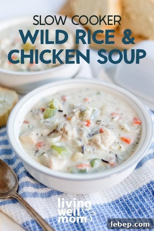 Creamy Slow Cooker Wild Rice and Chicken Soup Recipe 17 A bowl of creamy chicken and wild rice soup served with warm bread
