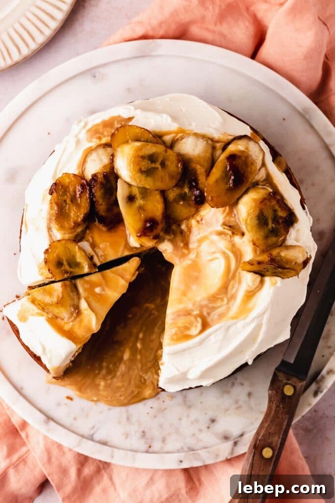 Decadent Banoffee Cake Recipe with Caramelized Bananas 2 cutting a slice of cake with bananas and caramel sauce