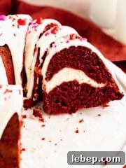 Closeup of red velvet bundt cake with cream cheese swirl and glaze