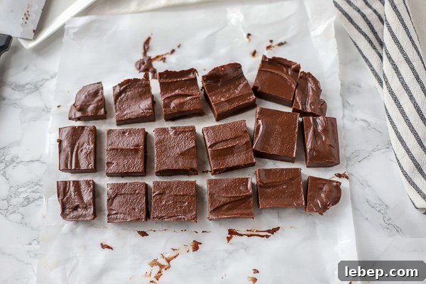 vegan fudge sliced into square pieces on white parchment paper