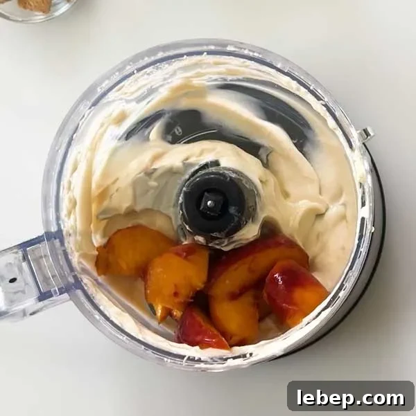 Adding sliced peaches to the food processor with some of the leftover cottage cheese ice cream mixture.