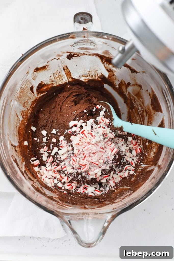 Gluten-Free Peppermint Chocolate Crinkle Cookies Recipe 6 Overhead view of adding crushed candy cane in peppermint chocolate crinkle batter
